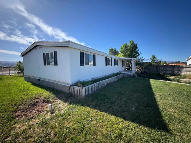 White siding exterior with black window shutters
