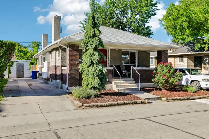 Brick and stucco exterior with a covered front porch featuring white railings
