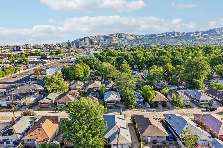 Aerial perspective showcasing an established neighborhood with a mix of residential structures and mature trees