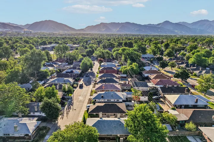 Residential neighborhood featuring mature tree-lined streets and mountain scenery