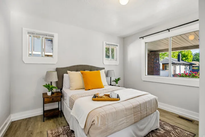 Bright room featuring wood-finish flooring, light grey painted walls, and white trim