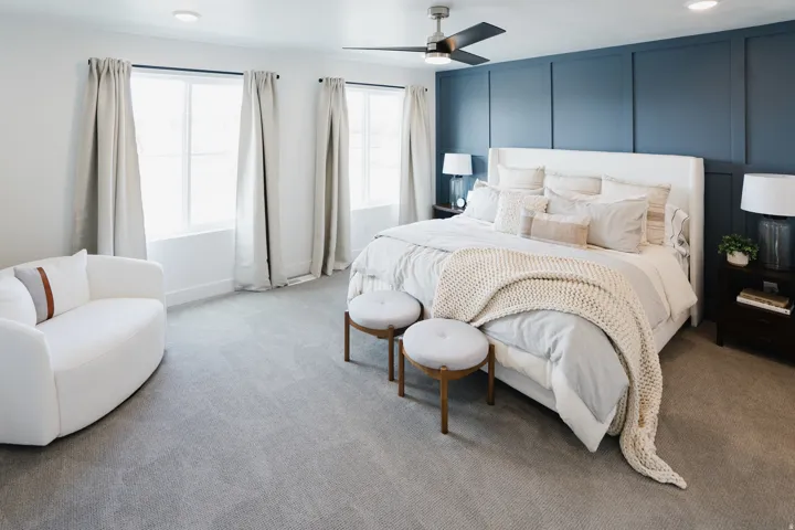 Spacious bedroom featuring board and batten accent wall, recessed lighting, and a ceiling fan