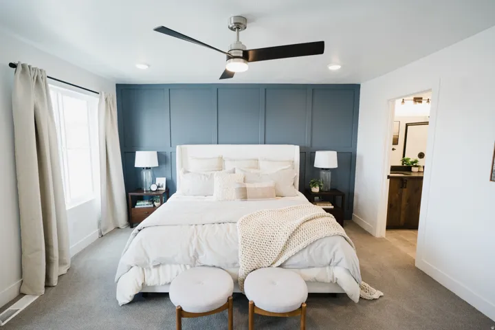 Spacious bedroom featuring a paneled accent wall, recessed lighting, and a contemporary ceiling fan with integrated light
