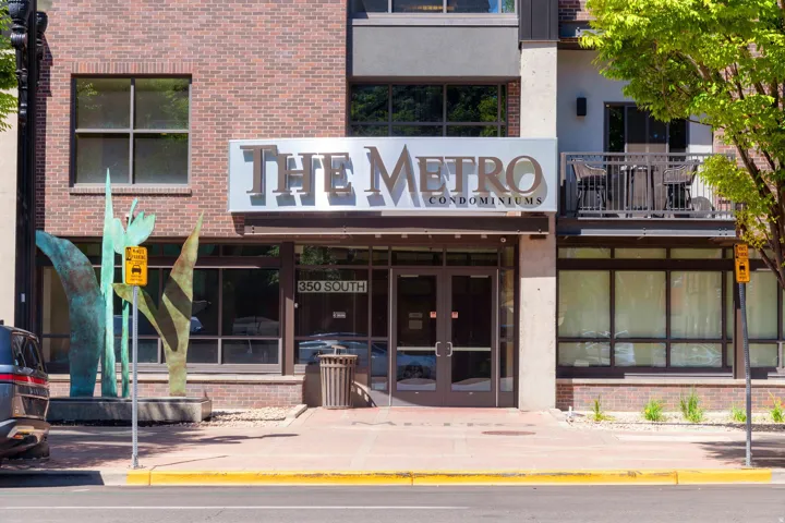 Brick and panel facade featuring "THE METRO CONDOMINIUMS" signage