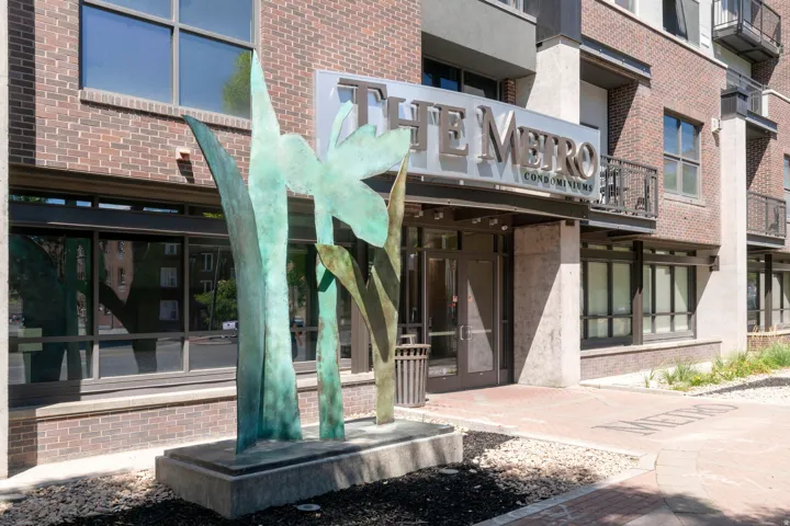 Building entrance with "THE METRO CONDOMINIUMS" signage