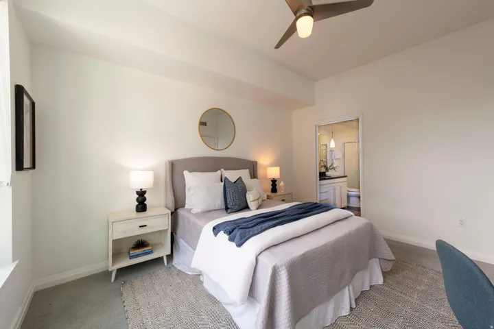 Carpeted room featuring light-toned walls and a ceiling fan