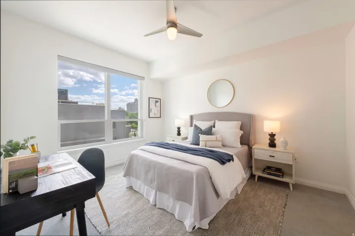 Spacious room featuring expansive windows, a ceiling fan with integrated lighting, and light-toned flooring