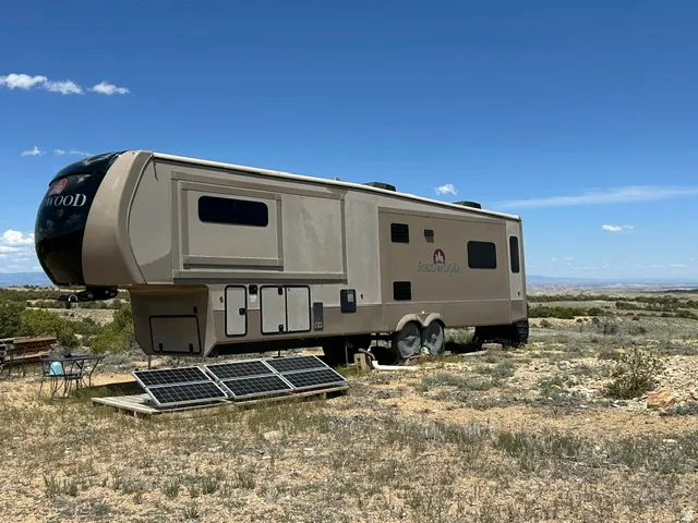 Fifth-wheel RV with multiple windows and exterior storage compartments