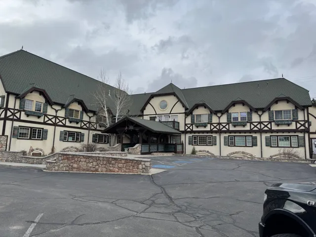 Tudor-style building featuring dark-trimmed gables and a prominent covered entryway