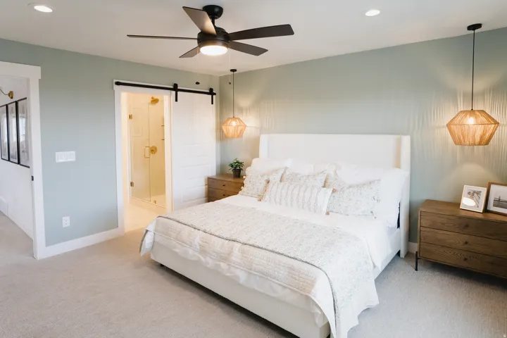Spacious bedroom featuring light-colored carpeting, recessed lighting, and a ceiling fan