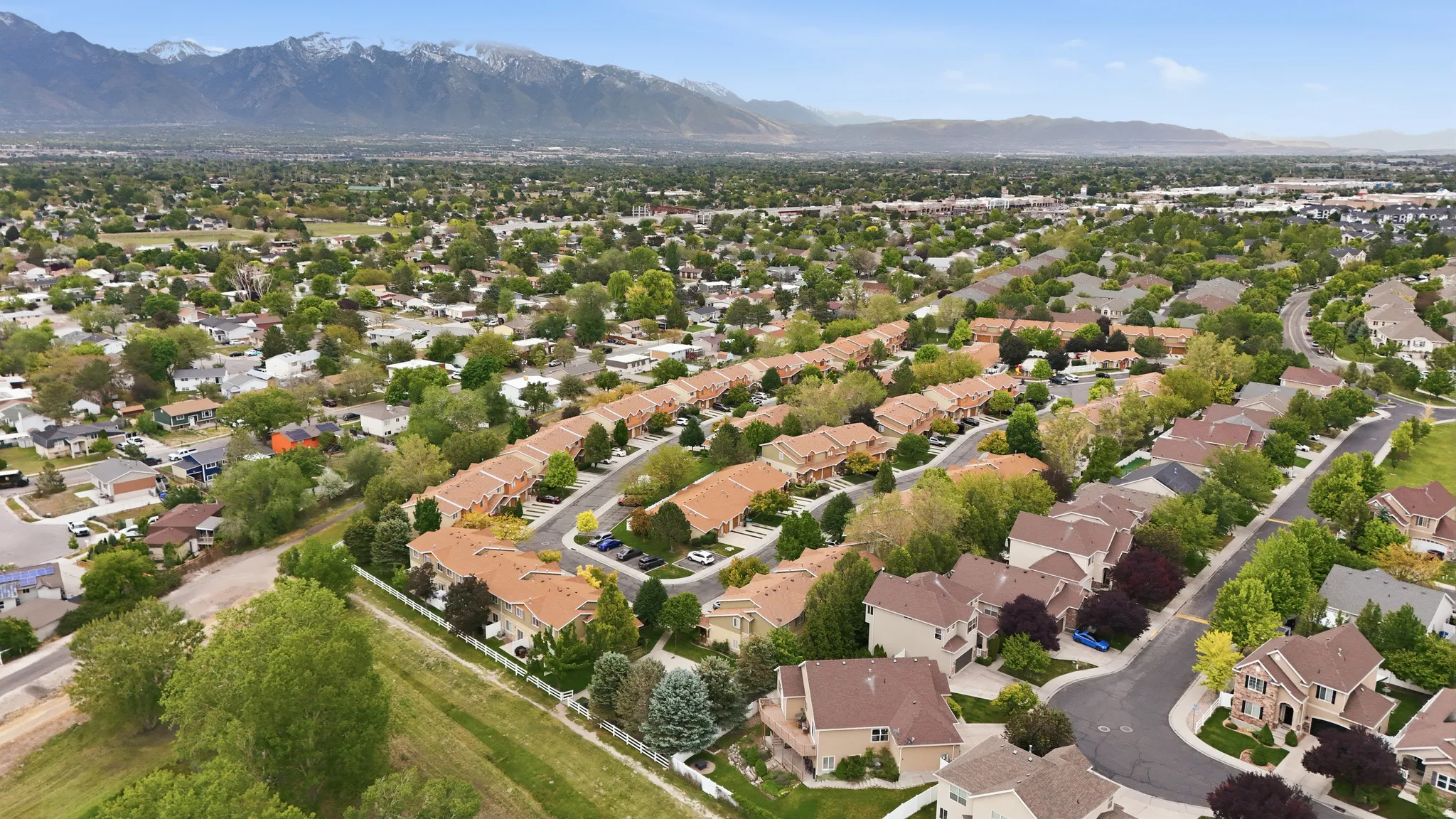Expansive suburban neighborhood featuring a mix of townhomes and single-family residences