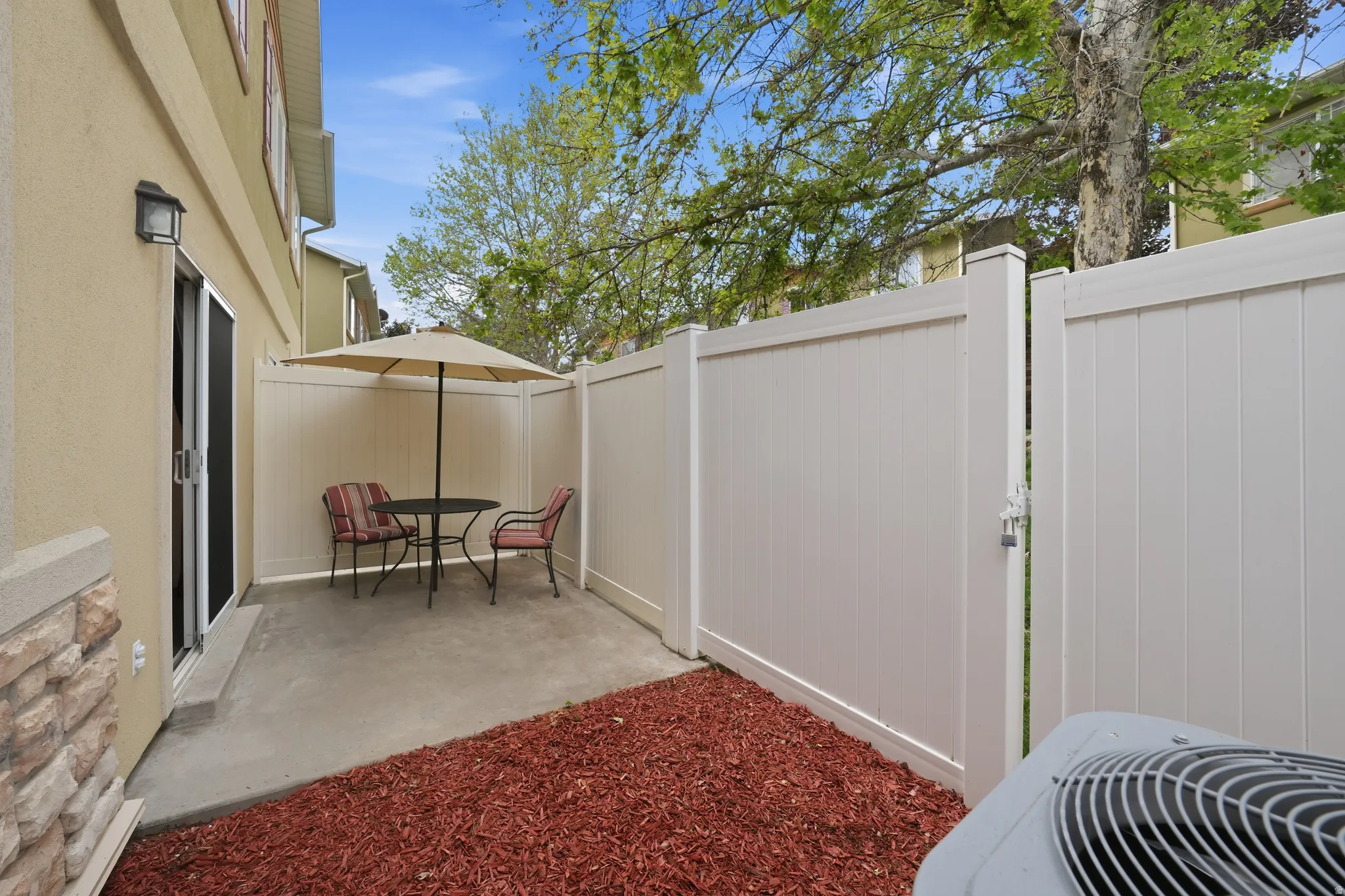 Private patio space featuring concrete flooring