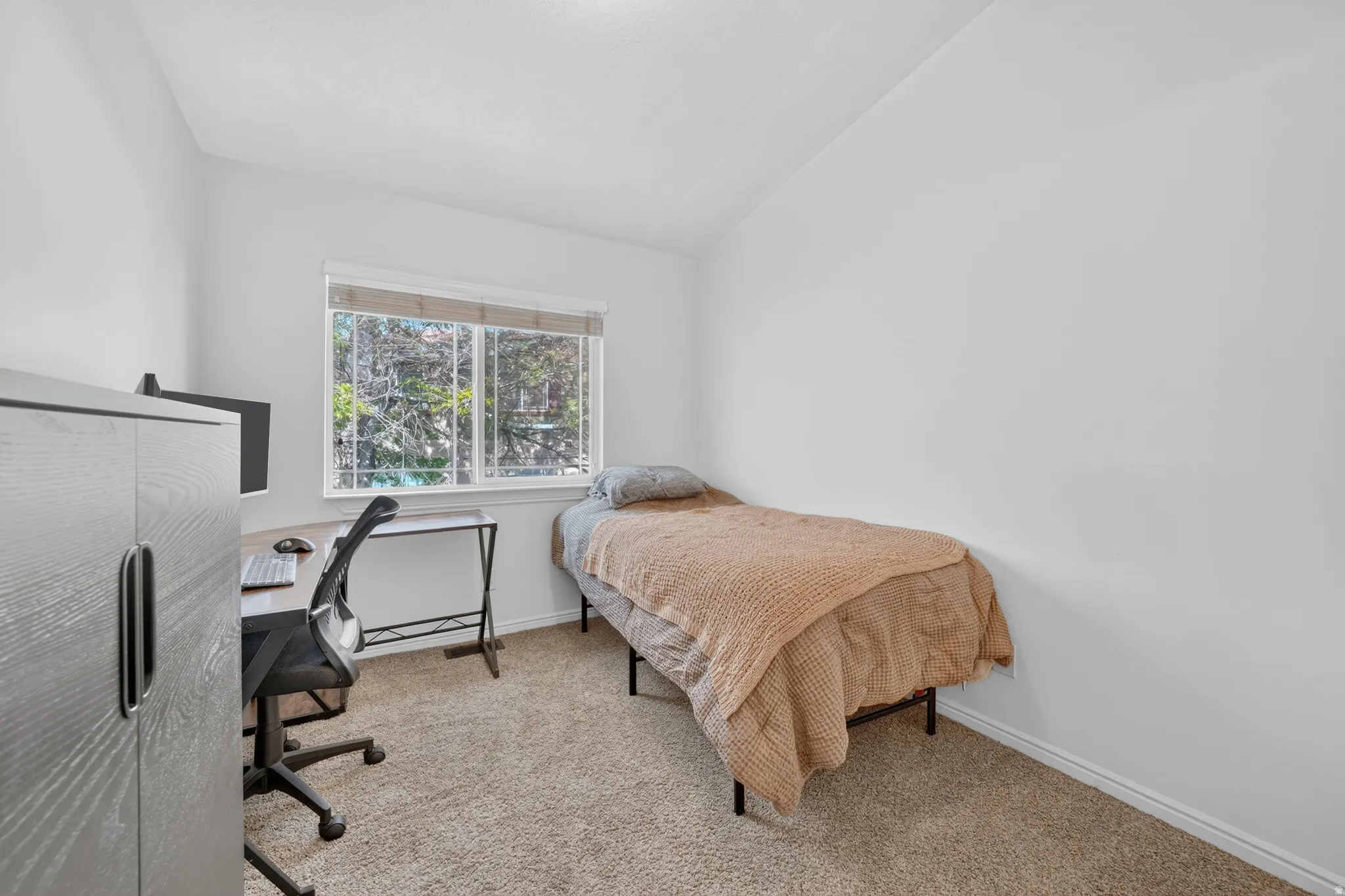 Carpeted room with a double-paned window offering exterior views