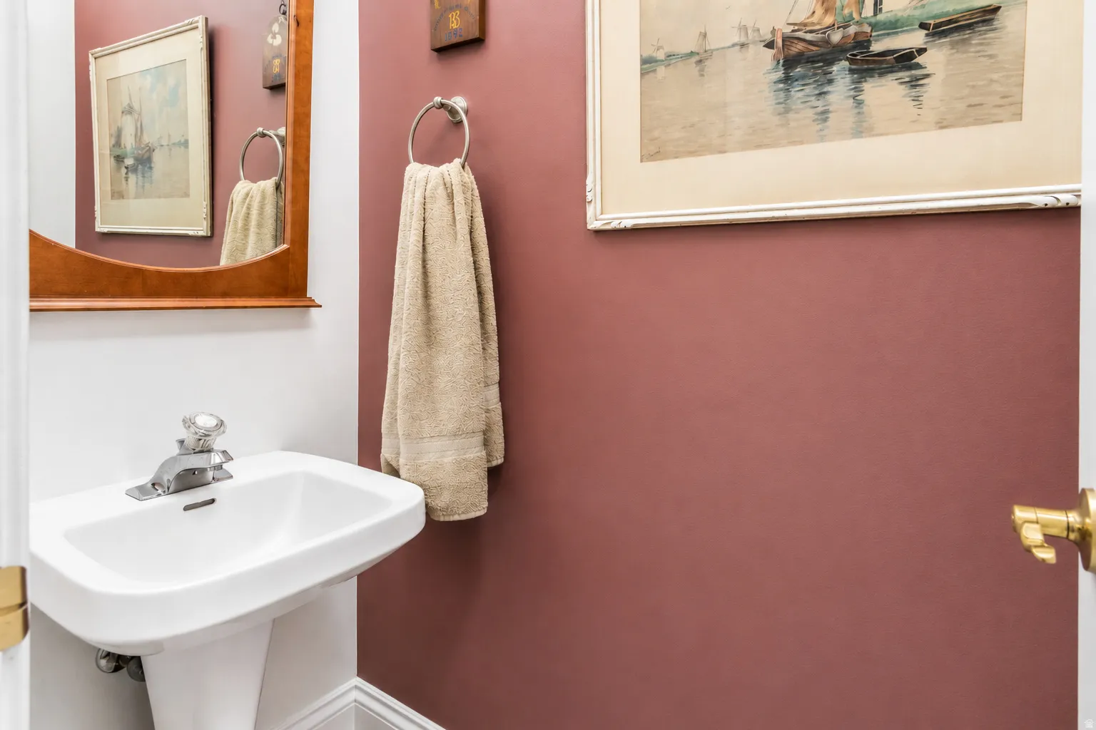 Pedestal sink with white ceramic basin and chrome faucet
