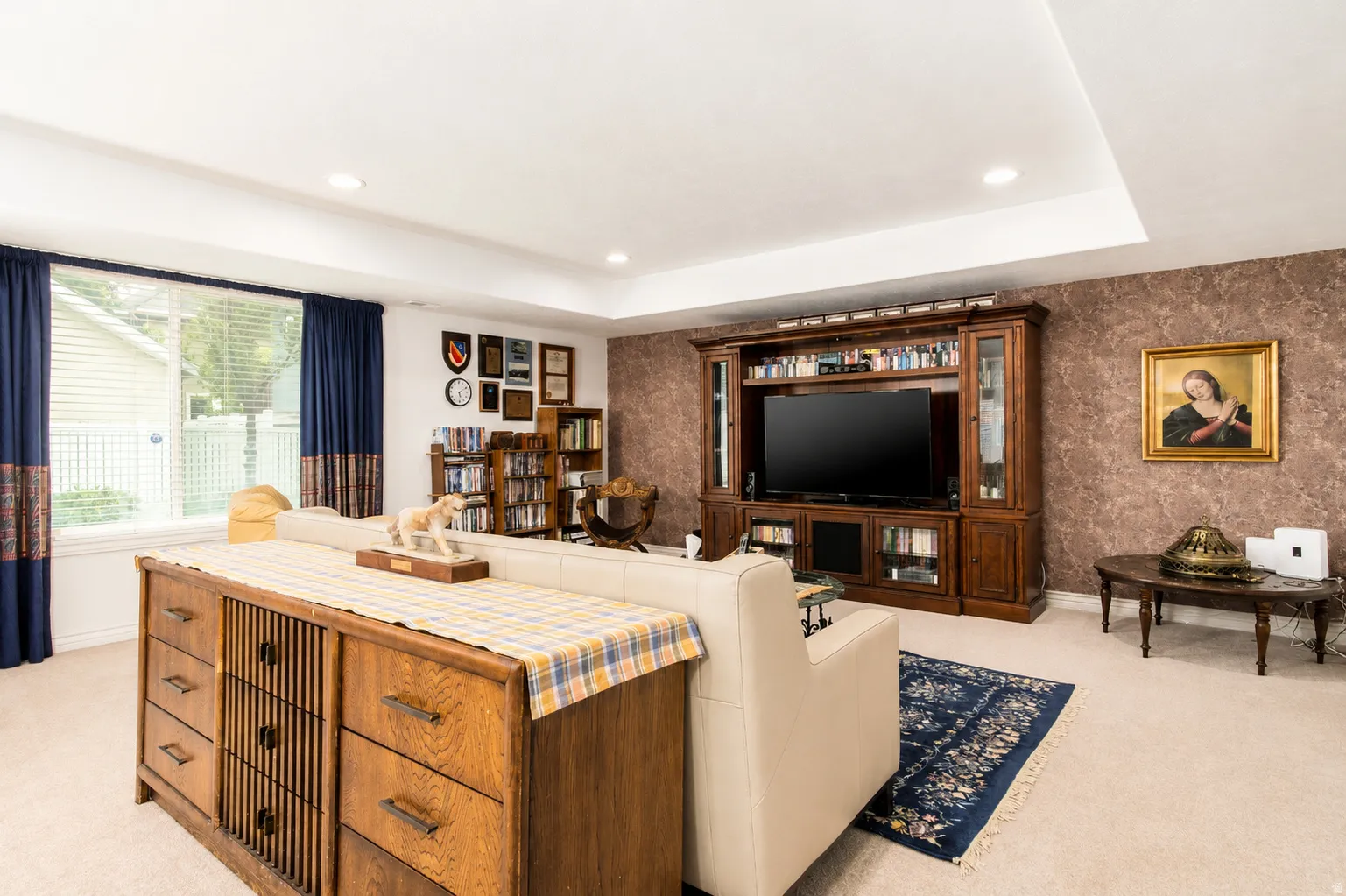 Spacious room featuring recessed lighting and a large window with horizontal blinds