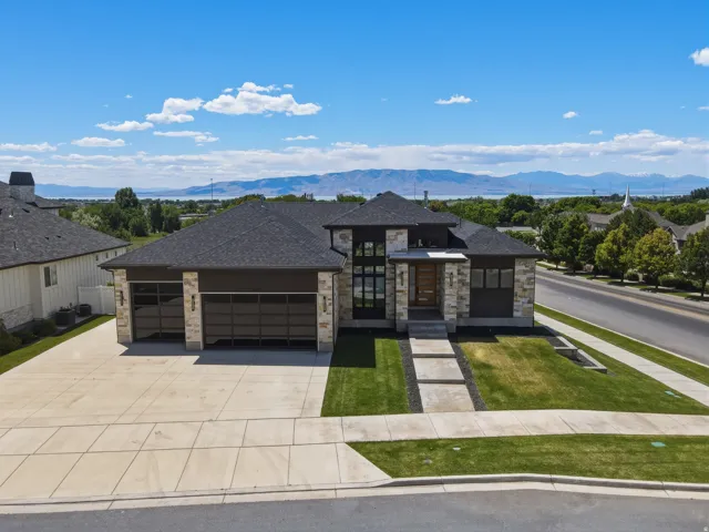Contemporary-style residence featuring a stone and dark-panel exterior