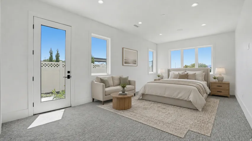 Spacious room featuring light-colored carpeting, recessed lighting, and a full-light panel door