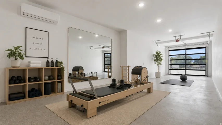 Spacious room featuring a full-width glass garage door, recessed lighting, and a wall-mounted air conditioning unit AI Pilates Option with flexspace