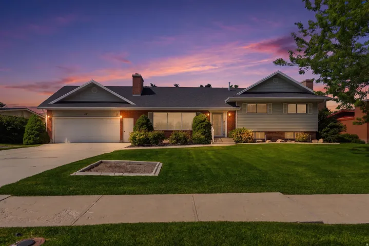 Traditional-style residence featuring a brick and siding exterior with a dark shingle roof