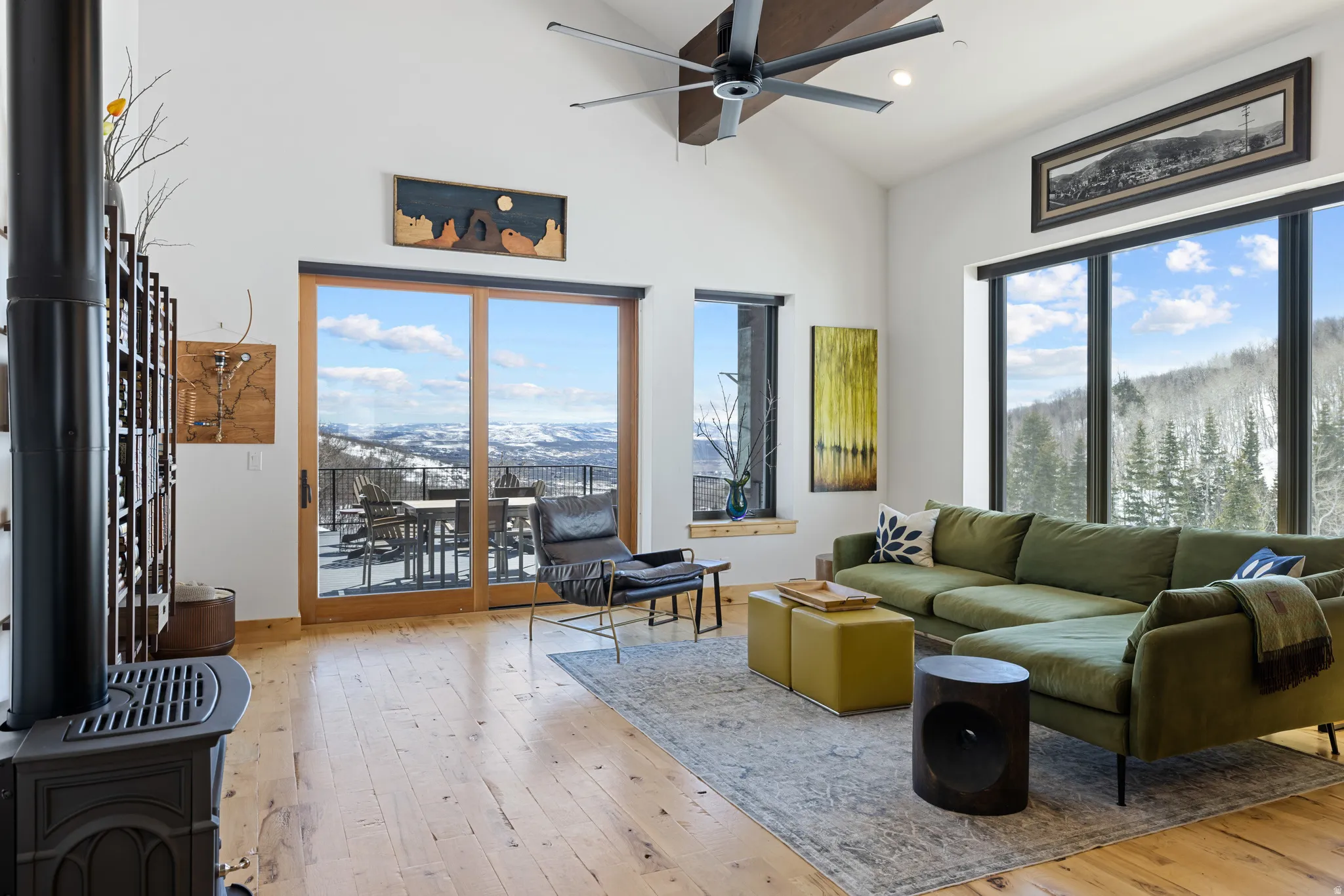 Living area featuring a mountain view, light wood-style floors, ceiling fan, vaulted ceiling, and recessed lighting