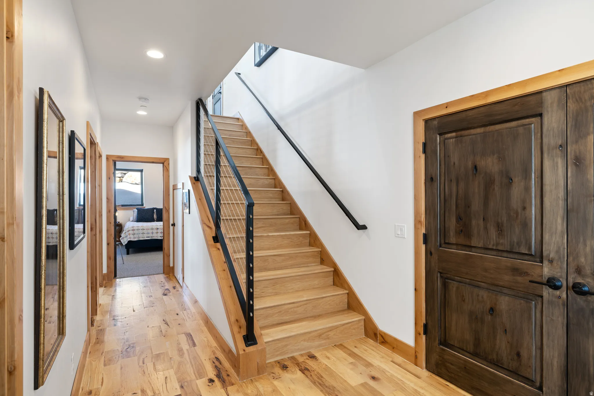 Stairway featuring hardwood / wood-style floors, plenty of natural light, and recessed lighting