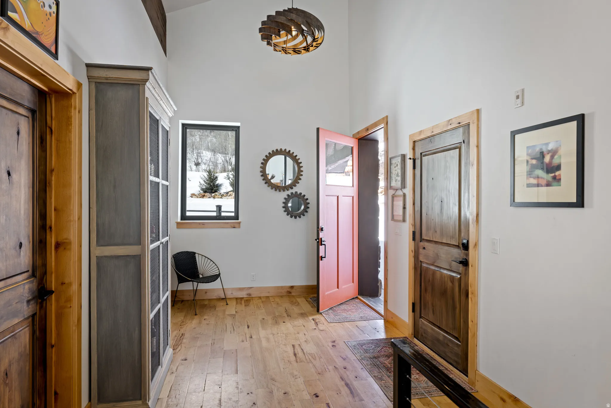 Foyer featuring light wood finished floors and a high ceiling