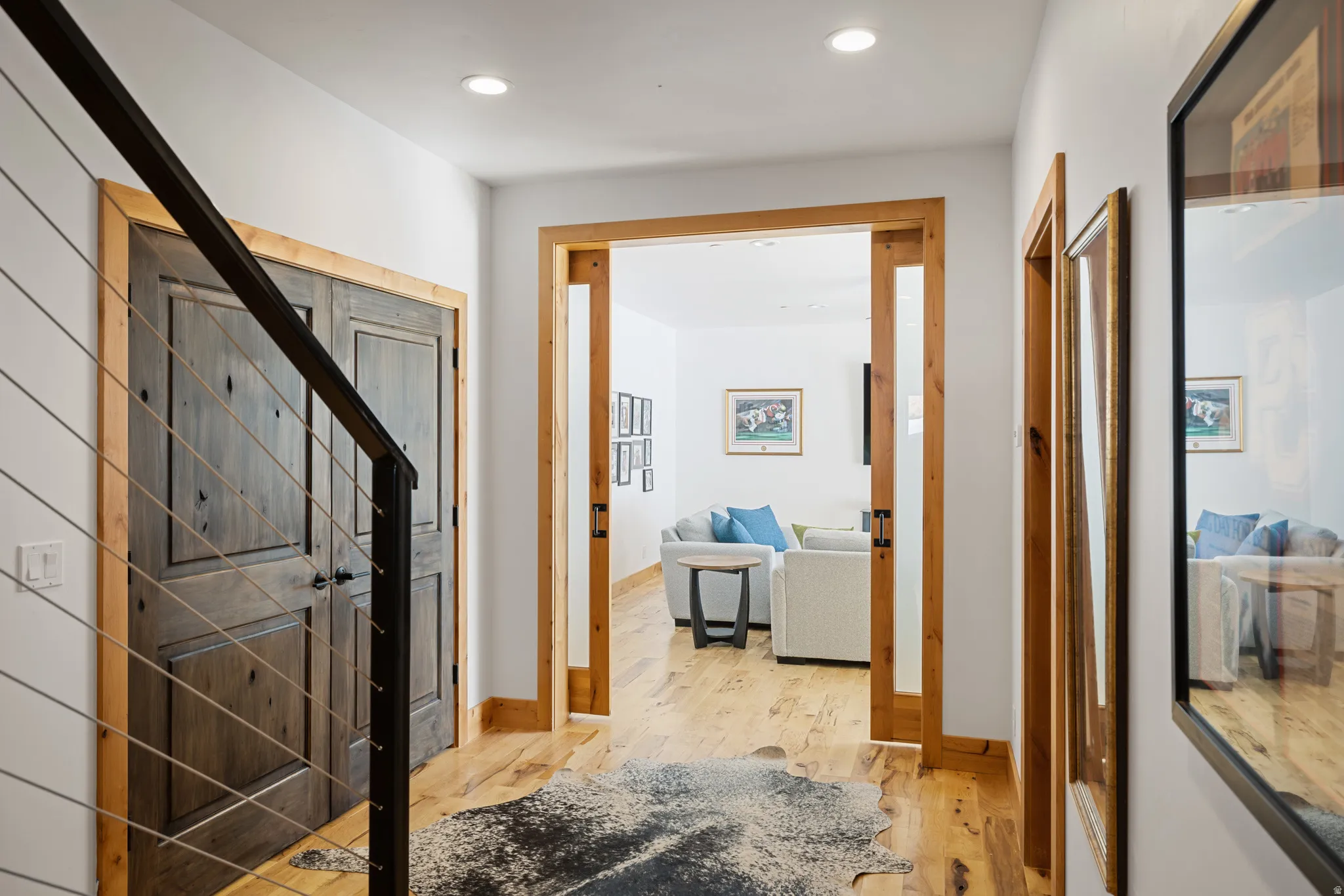 Hallway featuring light wood-style floors and recessed lighting