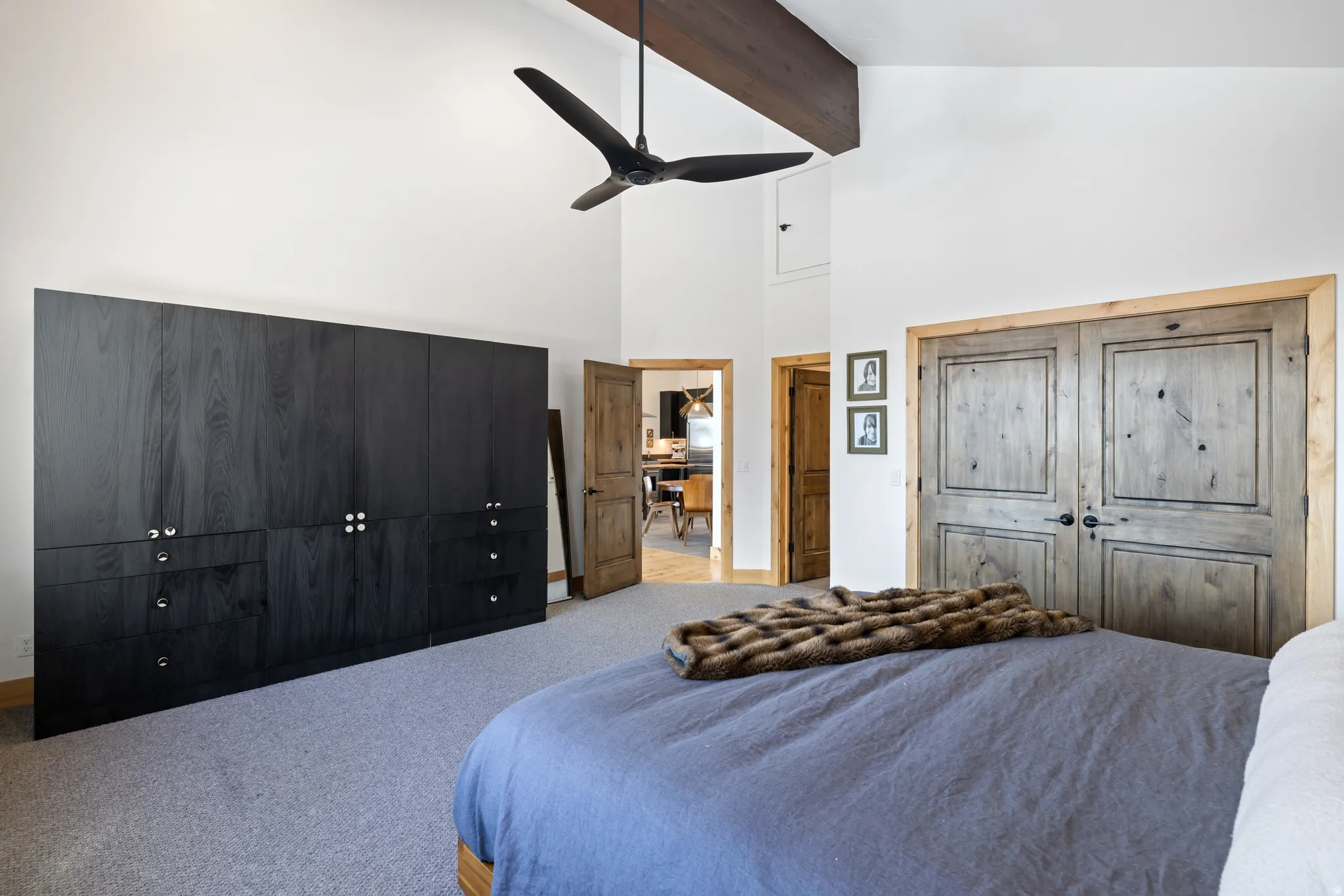 Carpeted bedroom featuring a ceiling fan and baseboards