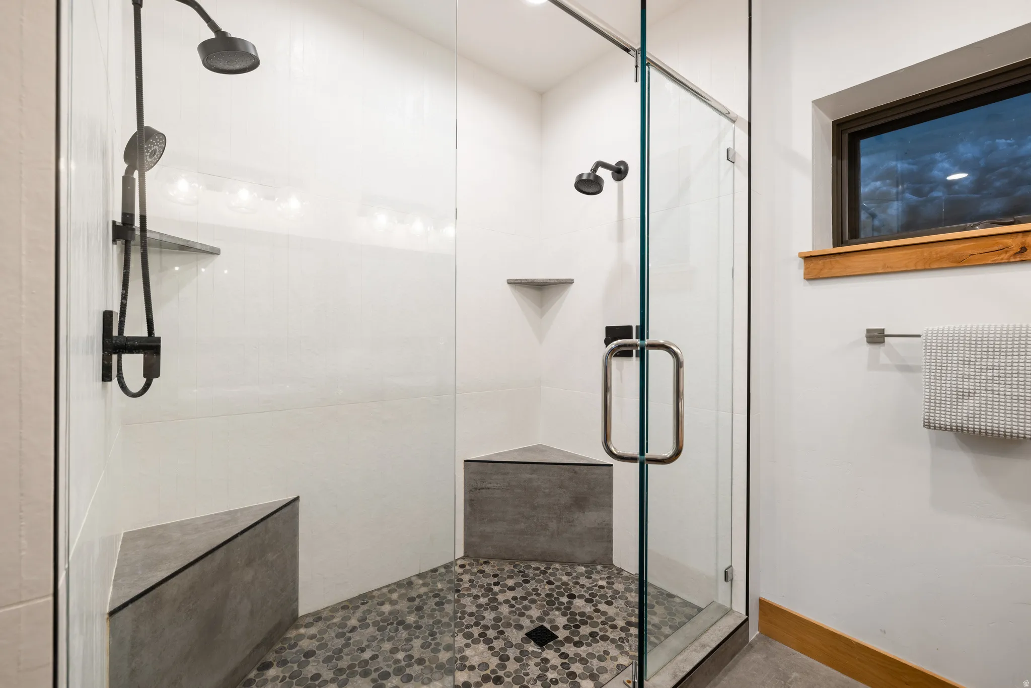 Full bath featuring a stall shower and baseboards