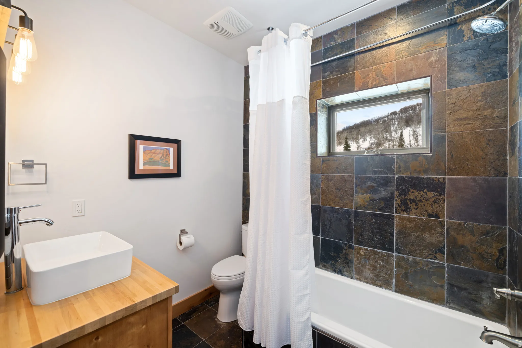 Bathroom with shower / bathtub combination with curtain and vanity