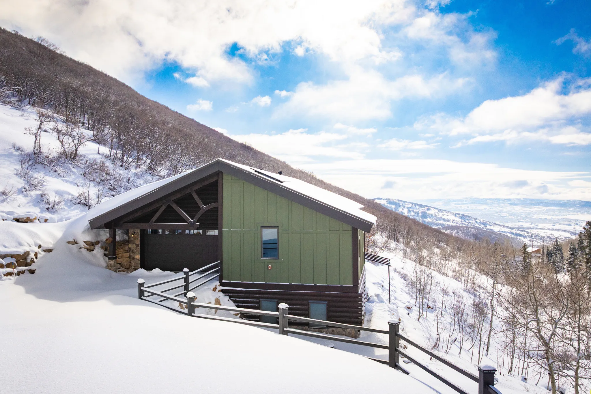 Snow covered property with a mountain view