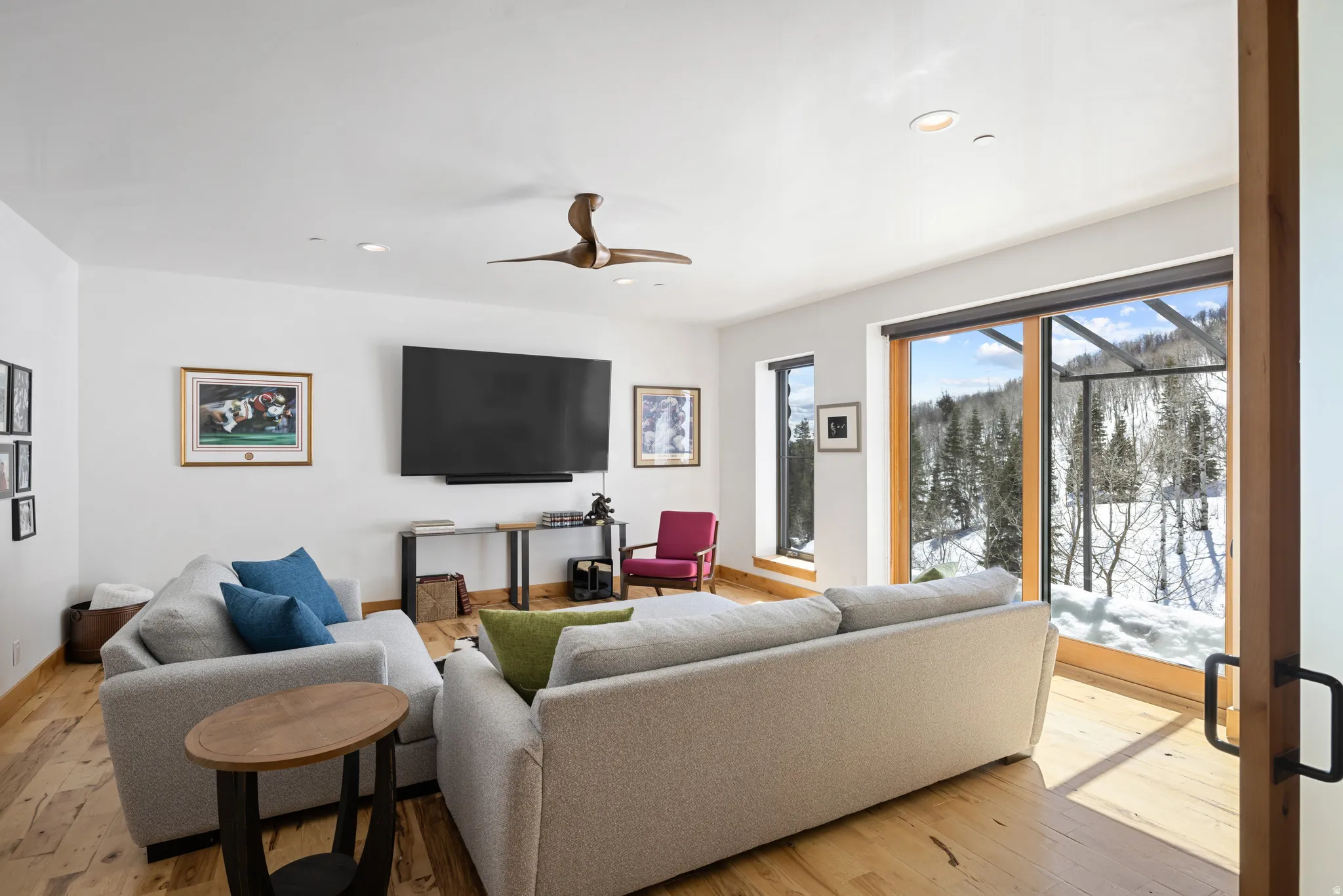Living room with light wood-style floors, a ceiling fan, and recessed lighting