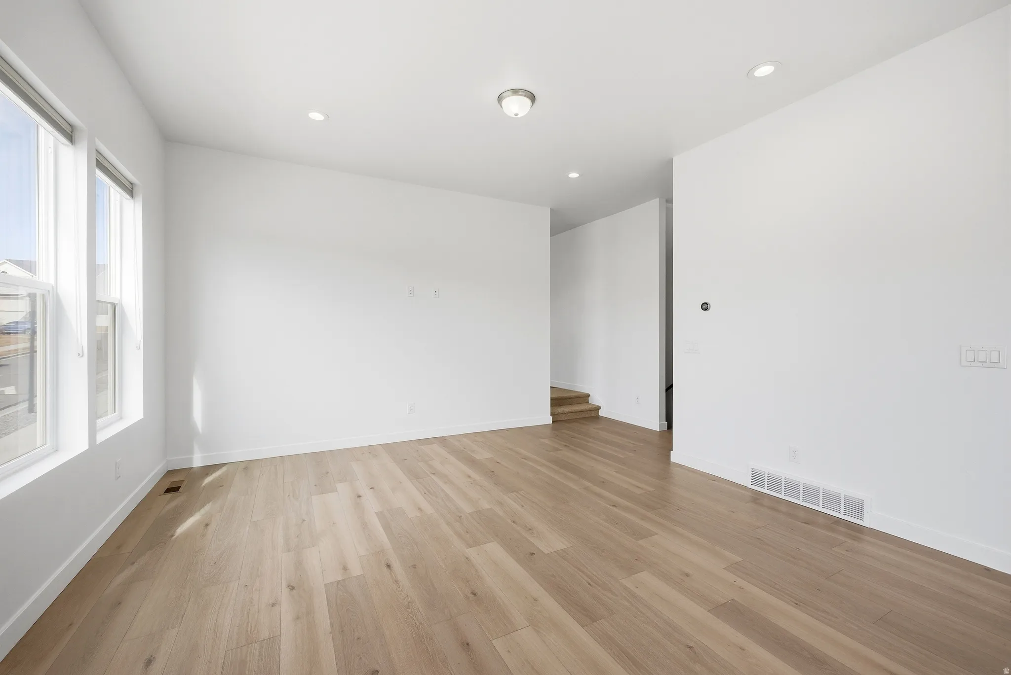 Unfurnished room featuring light wood-type flooring and recessed lighting