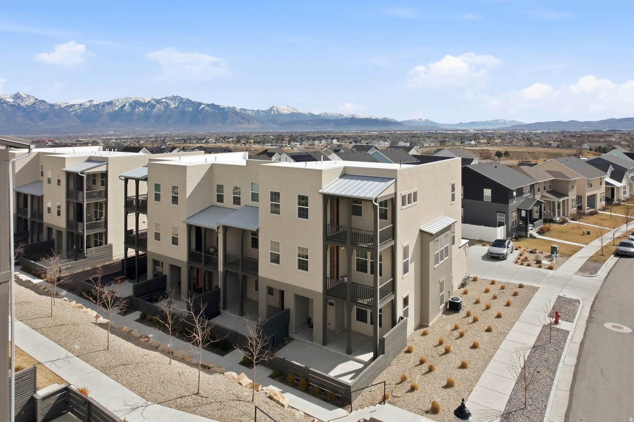 Exterior space featuring a residential view, stucco siding, and a mountain view