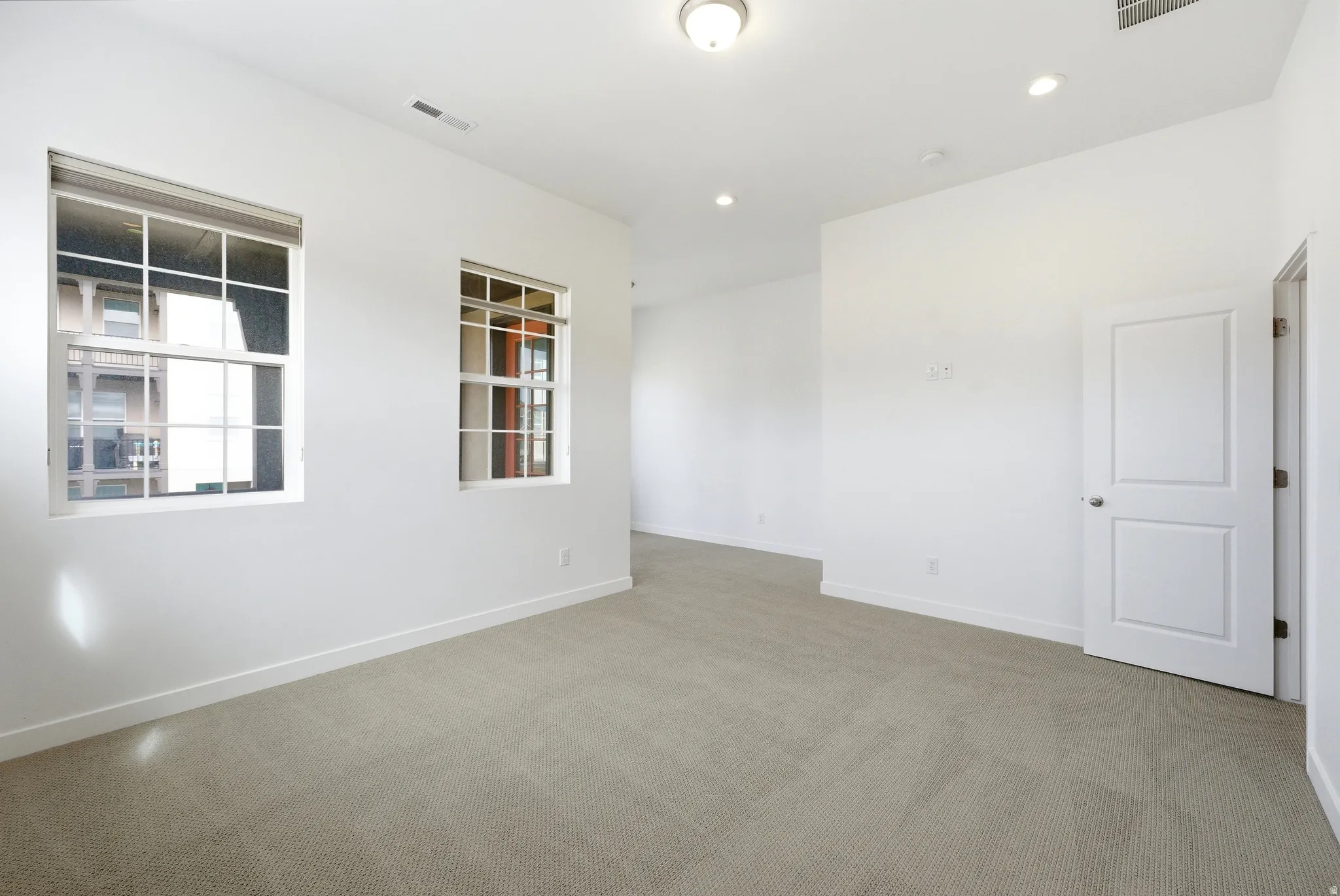 Unfurnished room featuring carpet and recessed lighting