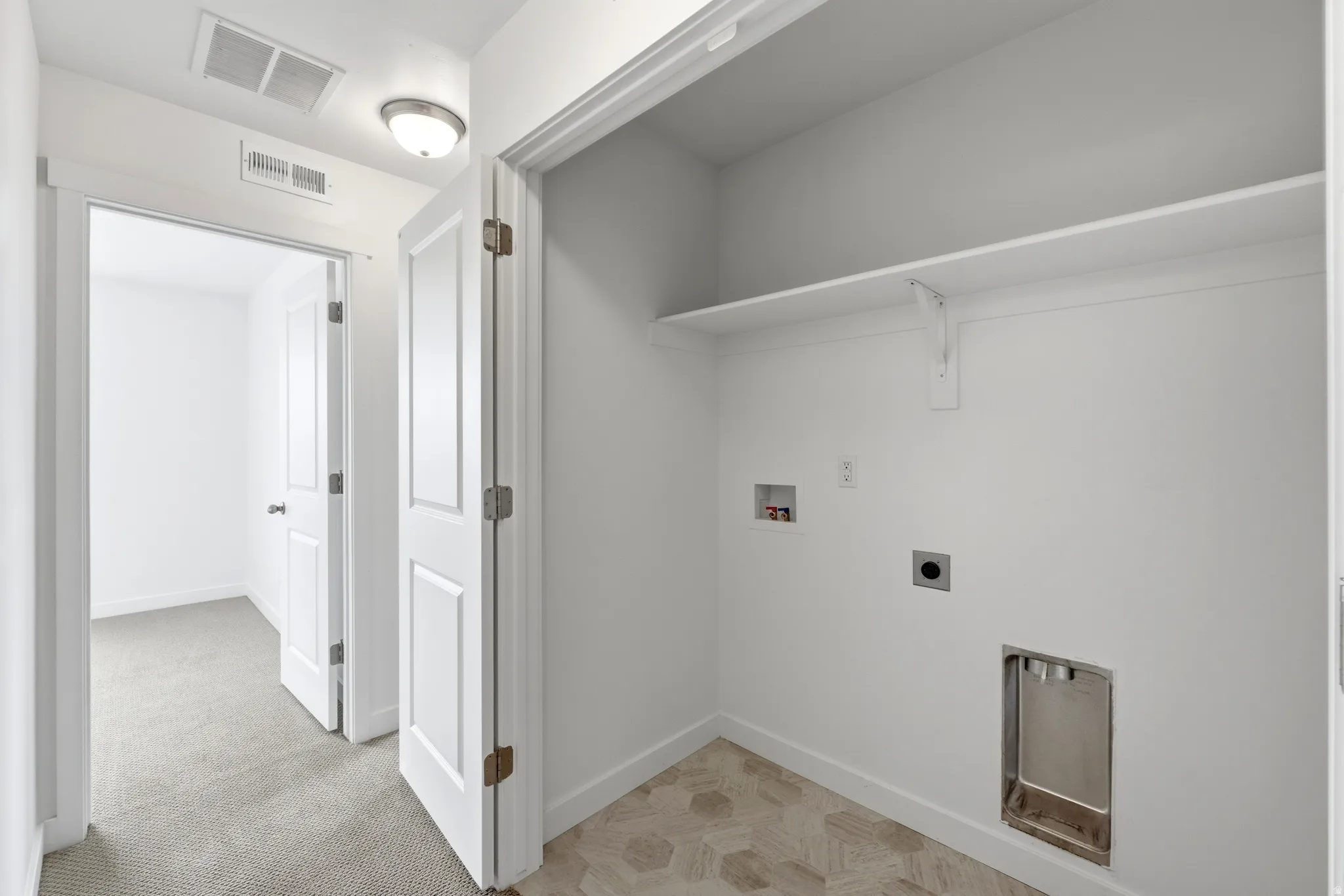 Laundry area with hookup for a washing machine and hookup for an electric dryer