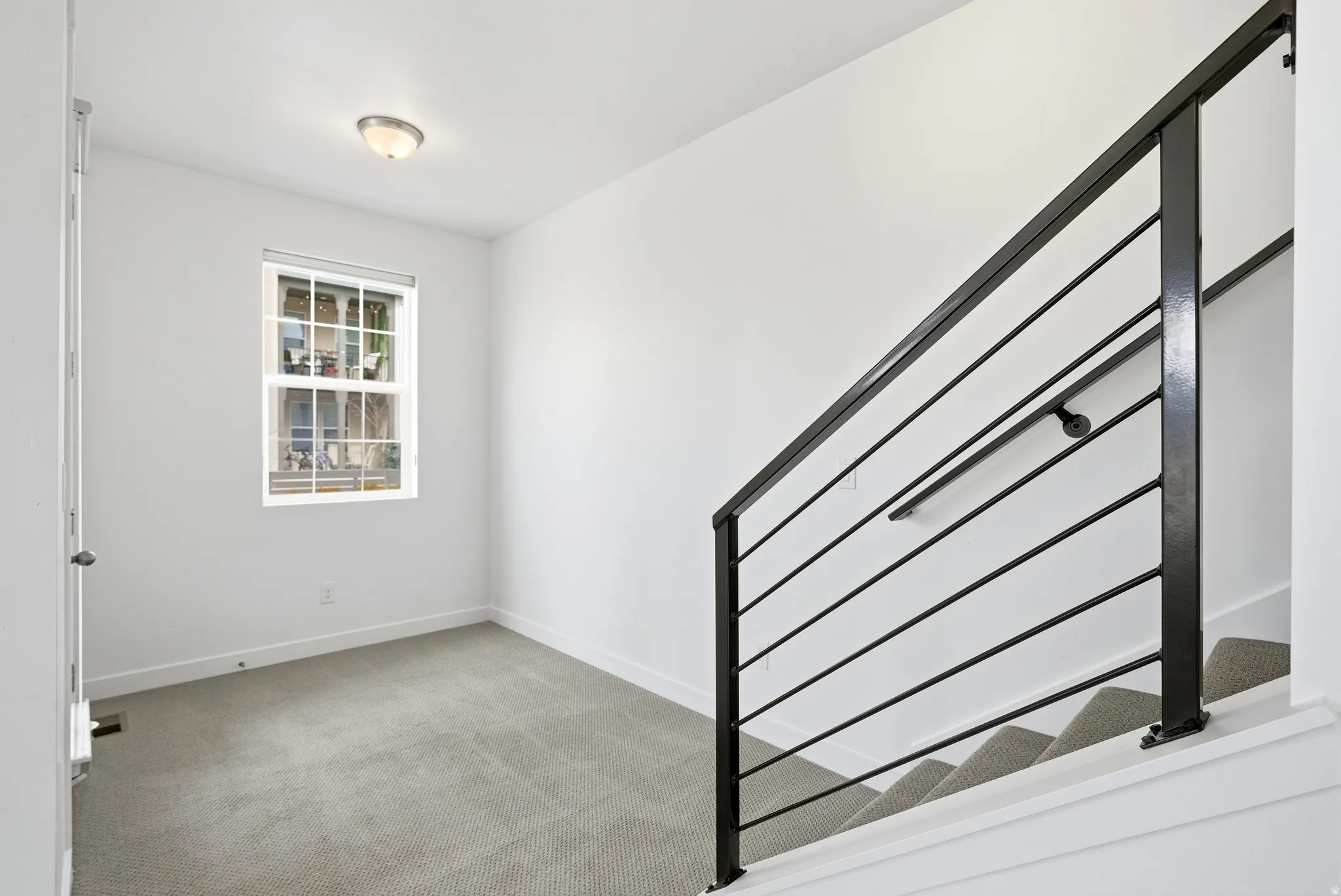 Stairway with carpet and baseboards