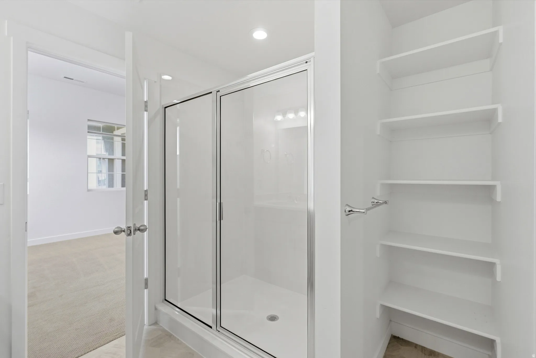 Bathroom featuring a stall shower, light carpet, a closet, and recessed lighting