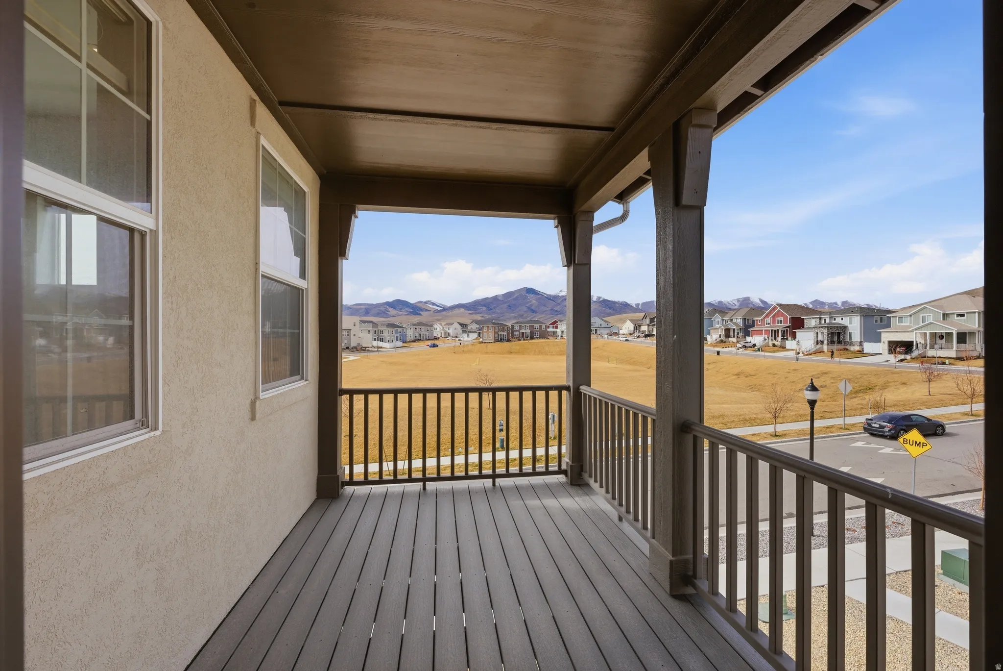 Porch with a residential view and a mountain view