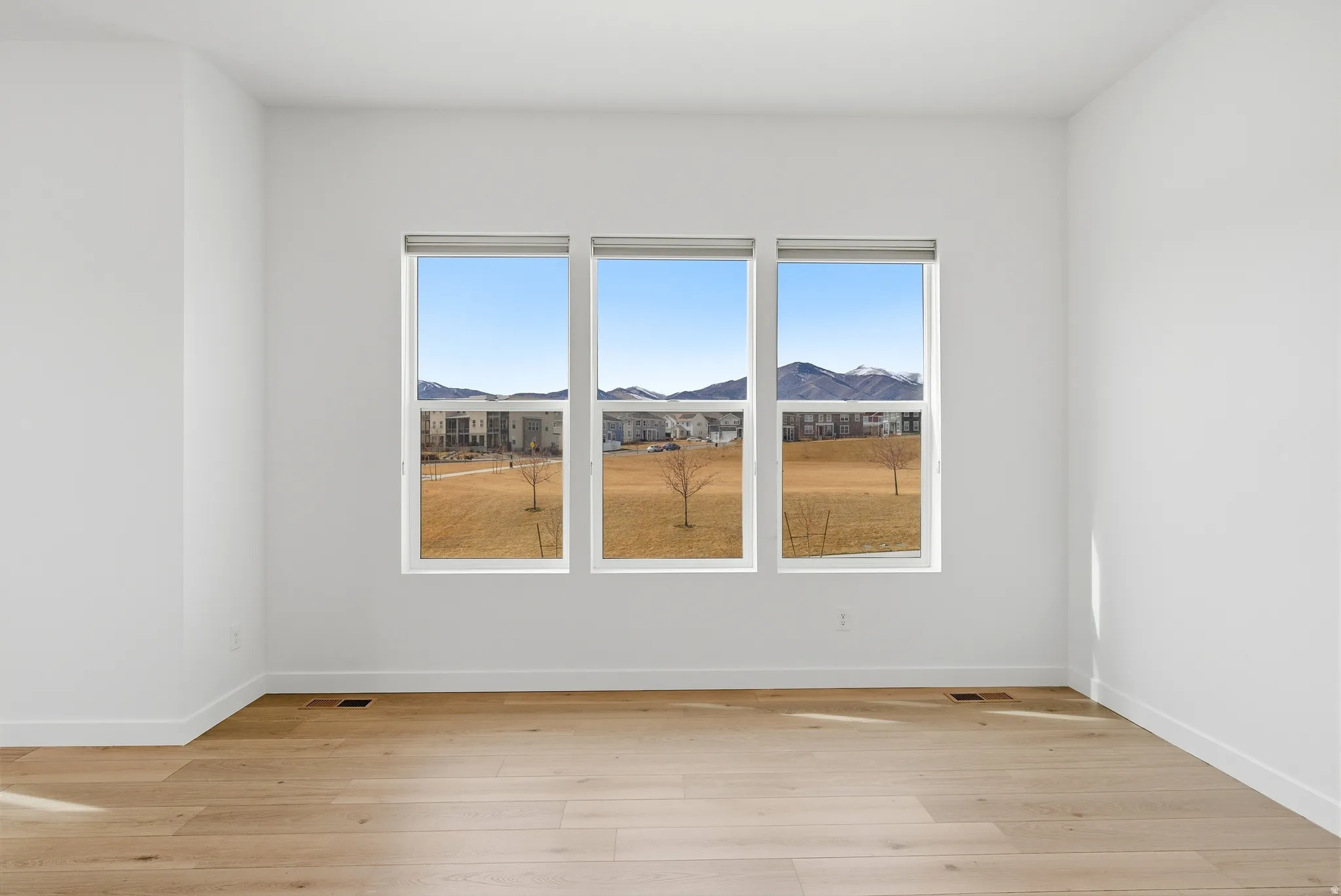 Spare room featuring light wood-style floors