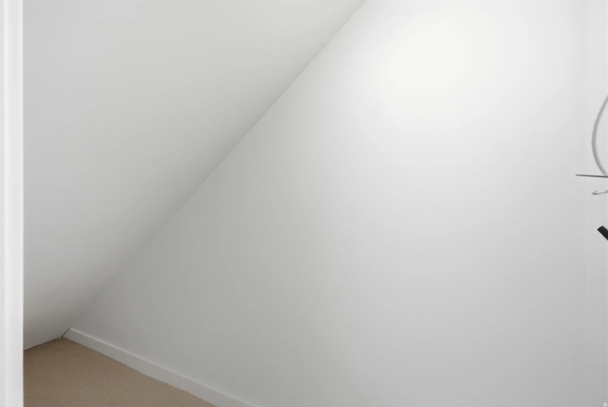 Detailed view of carpet flooring and baseboards