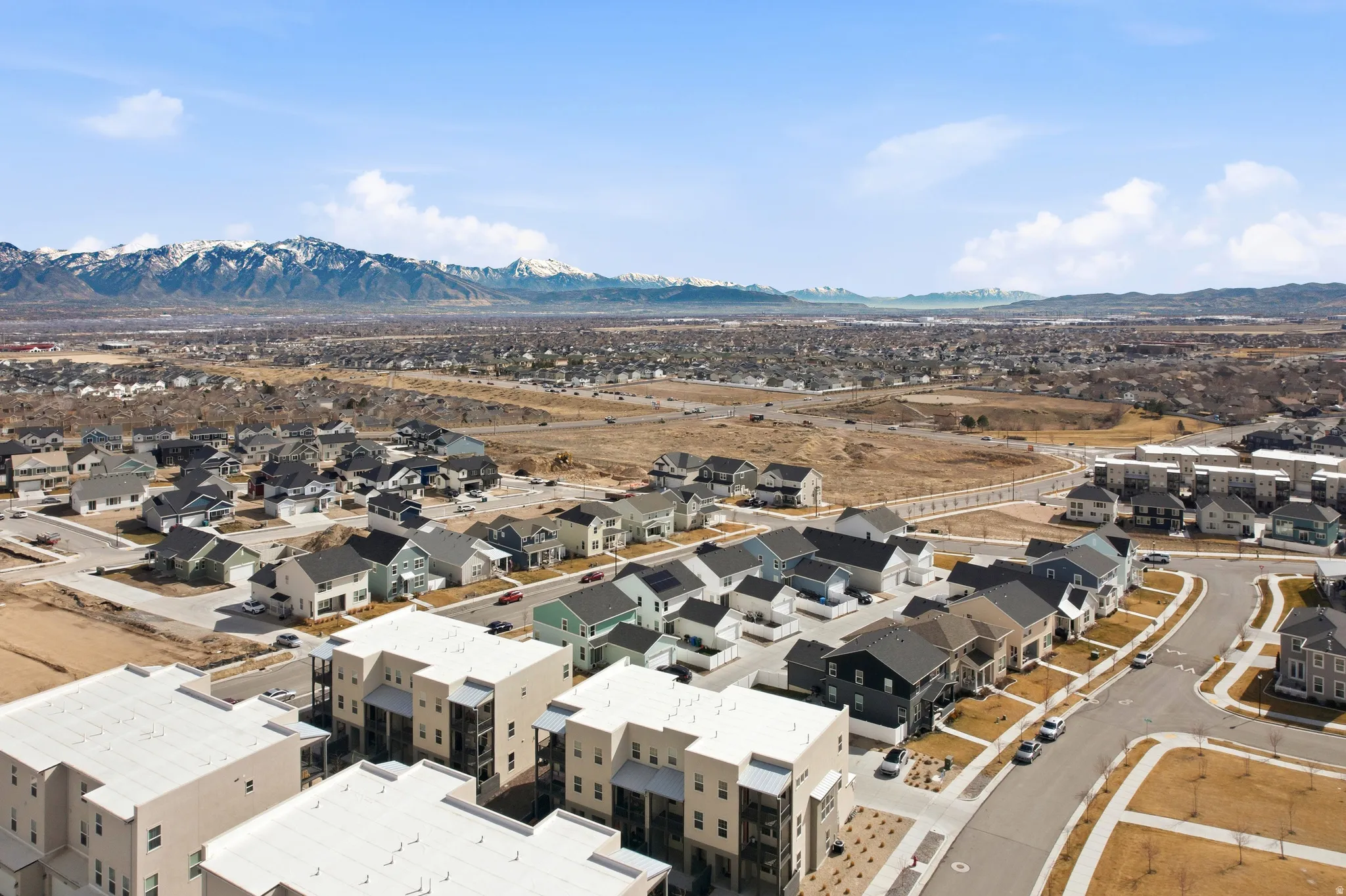 Aerial view of residential area featuring a mountainous background