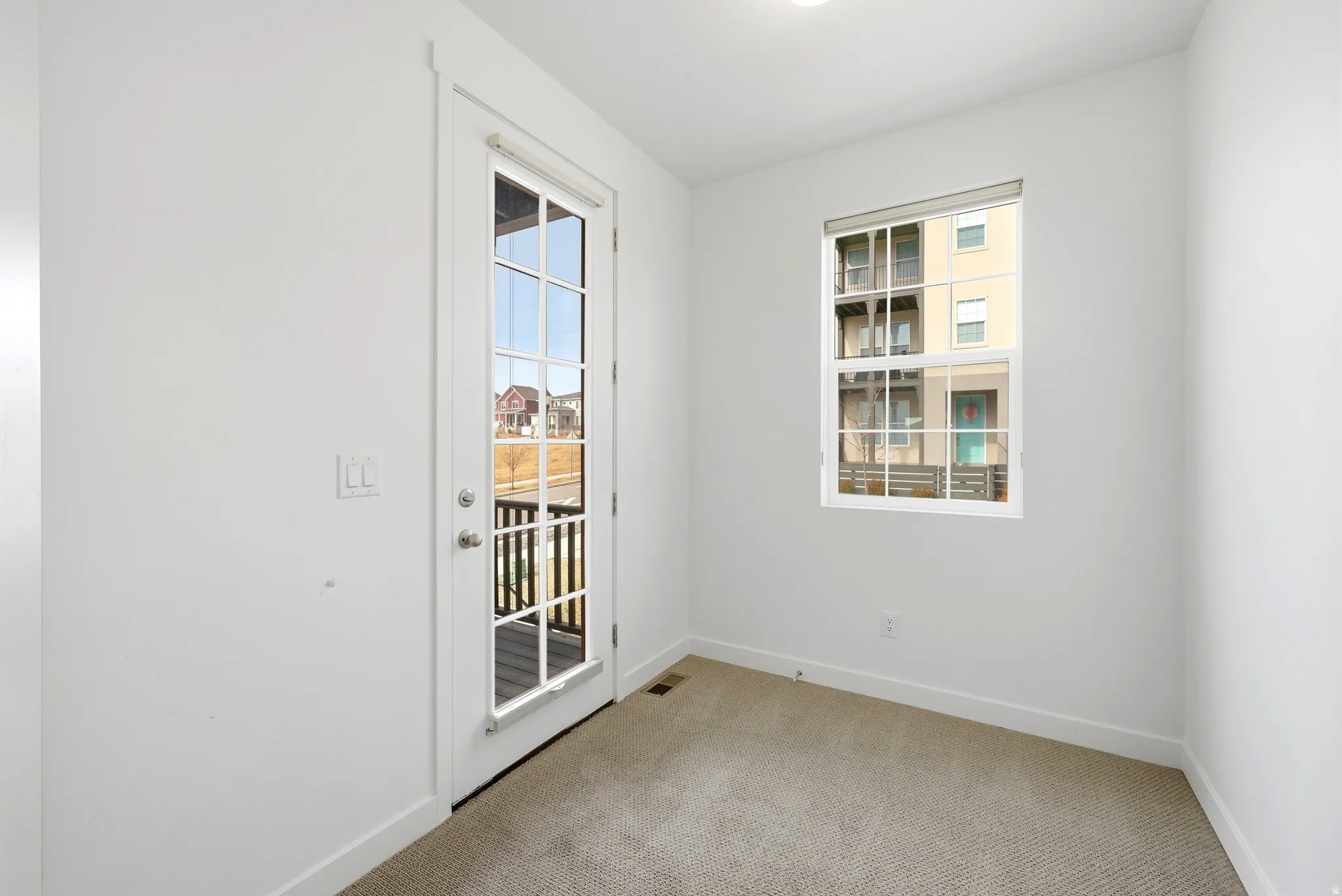 Unfurnished room with light carpet and baseboards