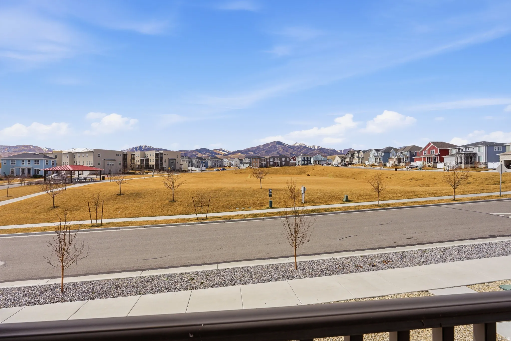 View of green lawn with a residential view