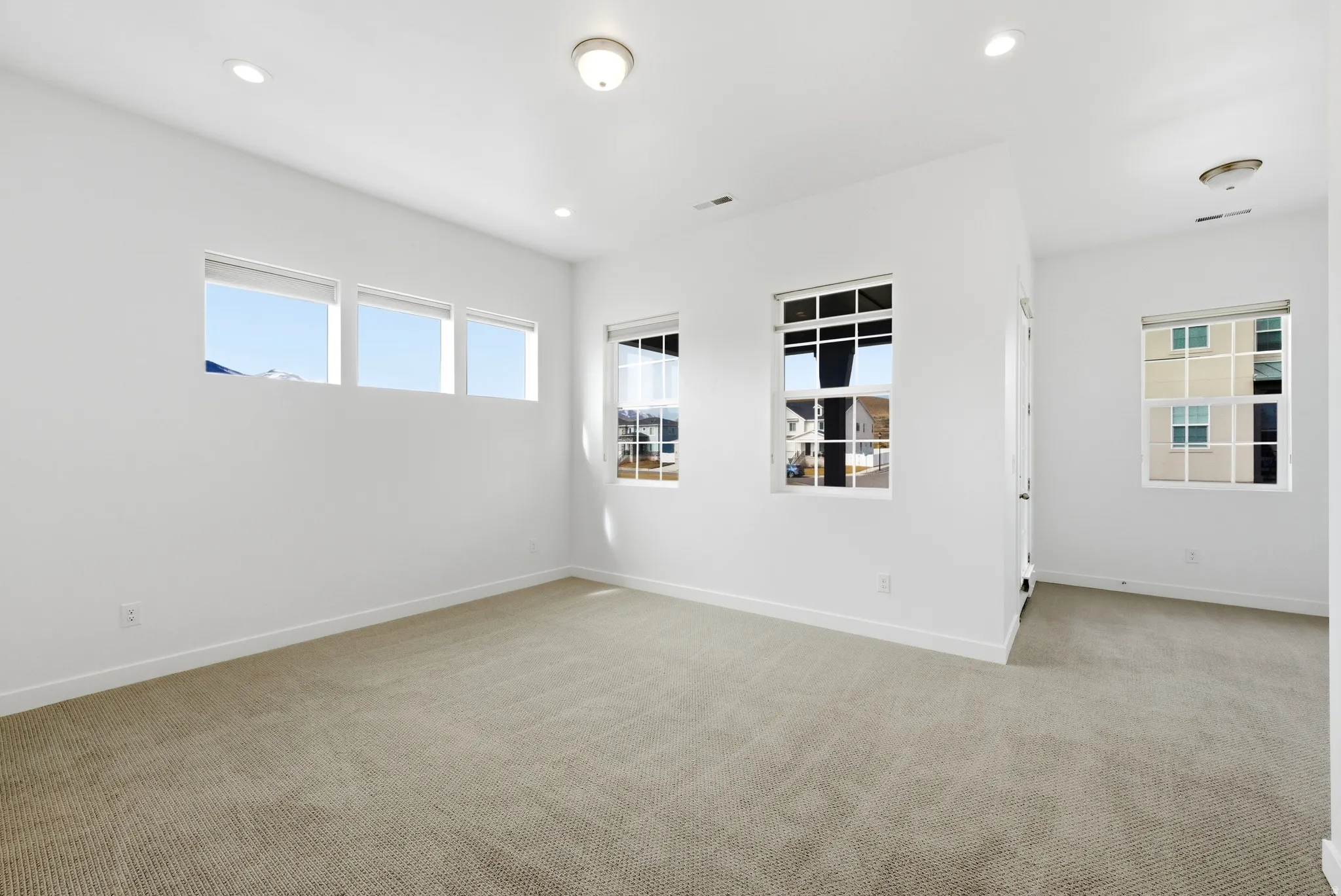 Empty room featuring light carpet and recessed lighting