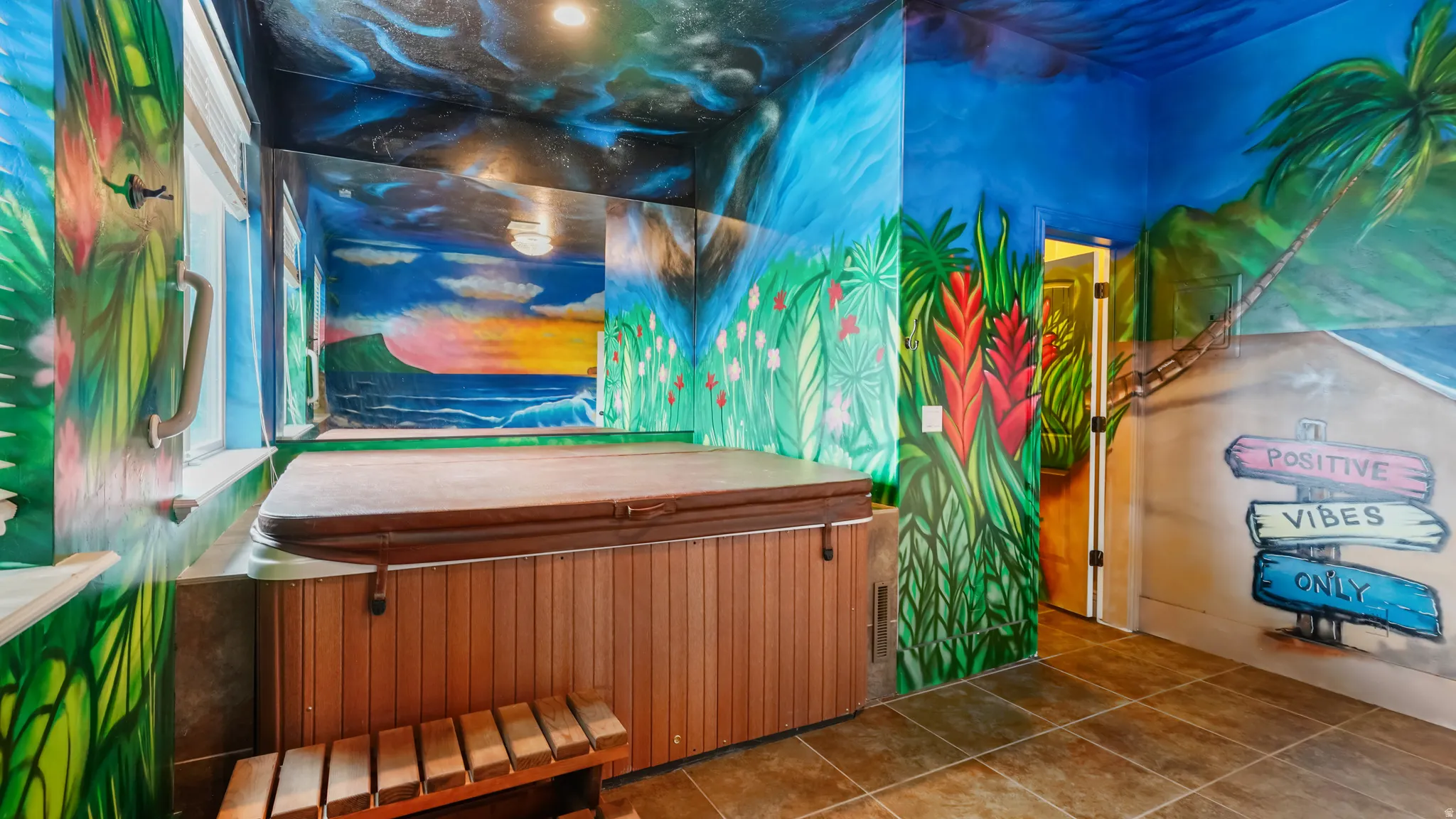 Indoor spa area featuring a large hot tub with wood-finish paneling, an integrated wood-slat step, and a tiled floor