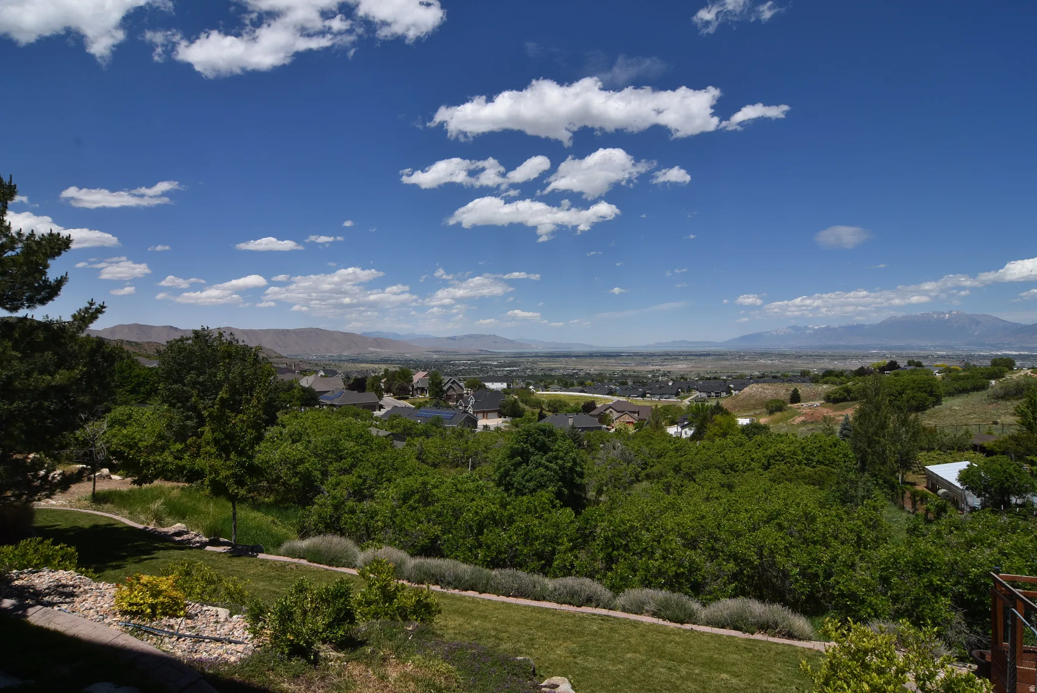 Views from walkout basement. Expansive landscaped grounds featuring a manicured lawn, established shrubs, and mature trees