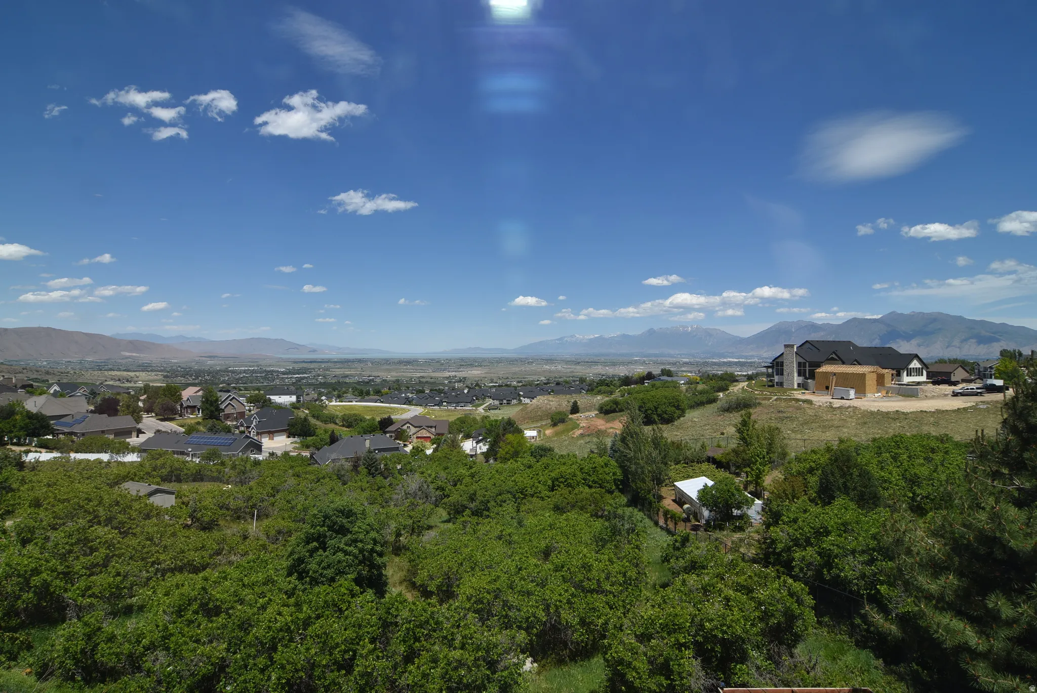 Expansive regional landscape featuring distant mountains and a valley below