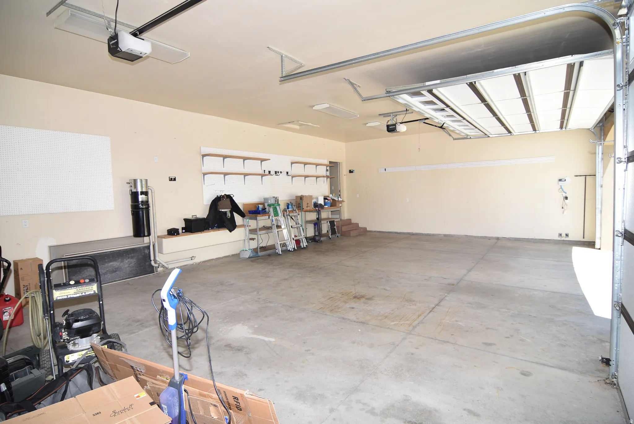 Spacious garage with light beige walls and a concrete floor