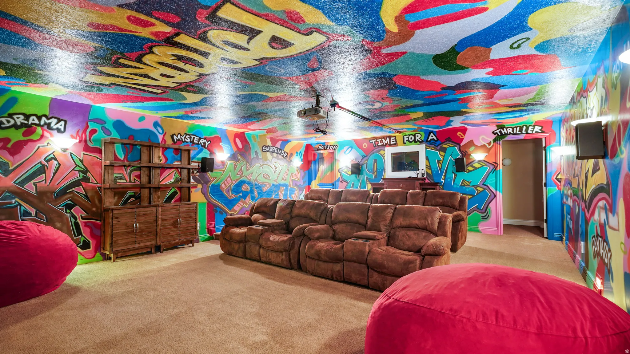 Media room featuring vibrant, multi-colored graffiti-style wall and ceiling art
